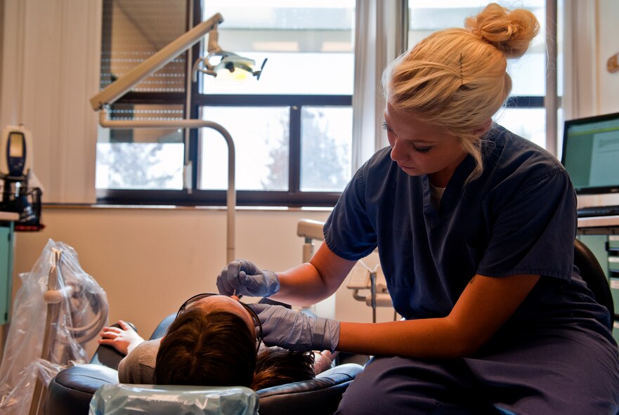 Airman 1st Class Shelby McIntyre, 39th Medical Operations Squadron dental assistant, applies fluoride to a military dependent during a dental screening Oct. 12, 2013, at Incirlik Air Base, Turkey. The dental day for dependents was run by volunteers from the 39th Medical Group who came in on their day off. (U.S. Air Force photo by Senior Airman Daniel Phelps/Released)