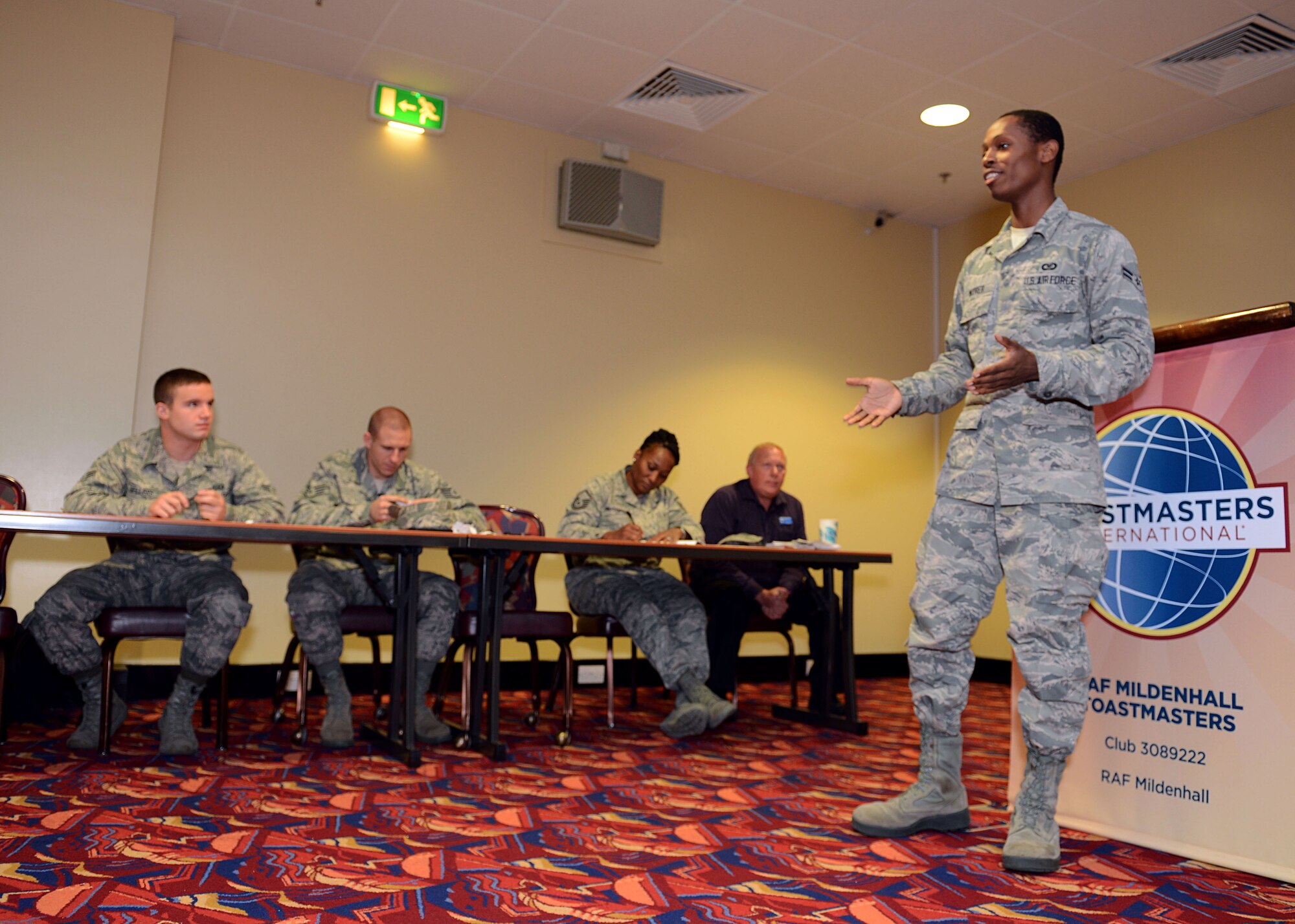 U.S. Air Force Airman 1st Class Tony Moorer, 100th Operations Support Squadron aviation resource manager from Detroit, evaluates a speech Oct. 3, 2013, in the Galaxy Club on RAF Mildenhall, England. As an evaluator, it's Moorer’s responsibility to give a speech highlighting positive aspects of another presentation and discussing areas needing improvement. (U.S. Air Force photo by Airman 1st Class Preston Webb/Released)