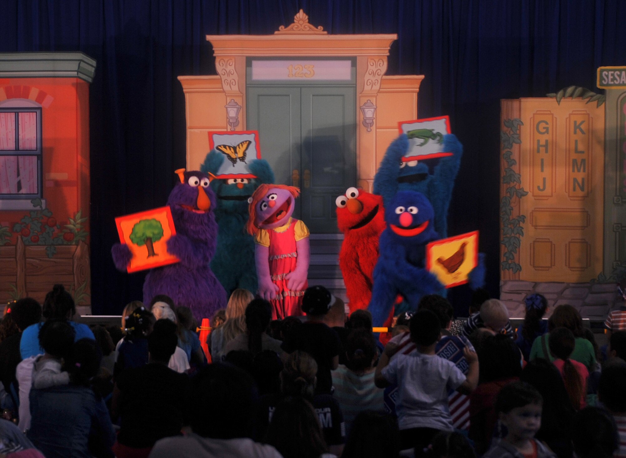 Elmo and friends from the Sesame Street Workshop perform for more than 1,200 military children and their families in the Fitness Center at Osan Air Base, Republic of Korea, Oct. 11, 2013. The Sesame Street Workshop collaborated with the United Service Organization to provide the opportunity for bases across the Pacific Air Forces. (U.S. Air Force photo/Senior Airman Kristina Overton)
