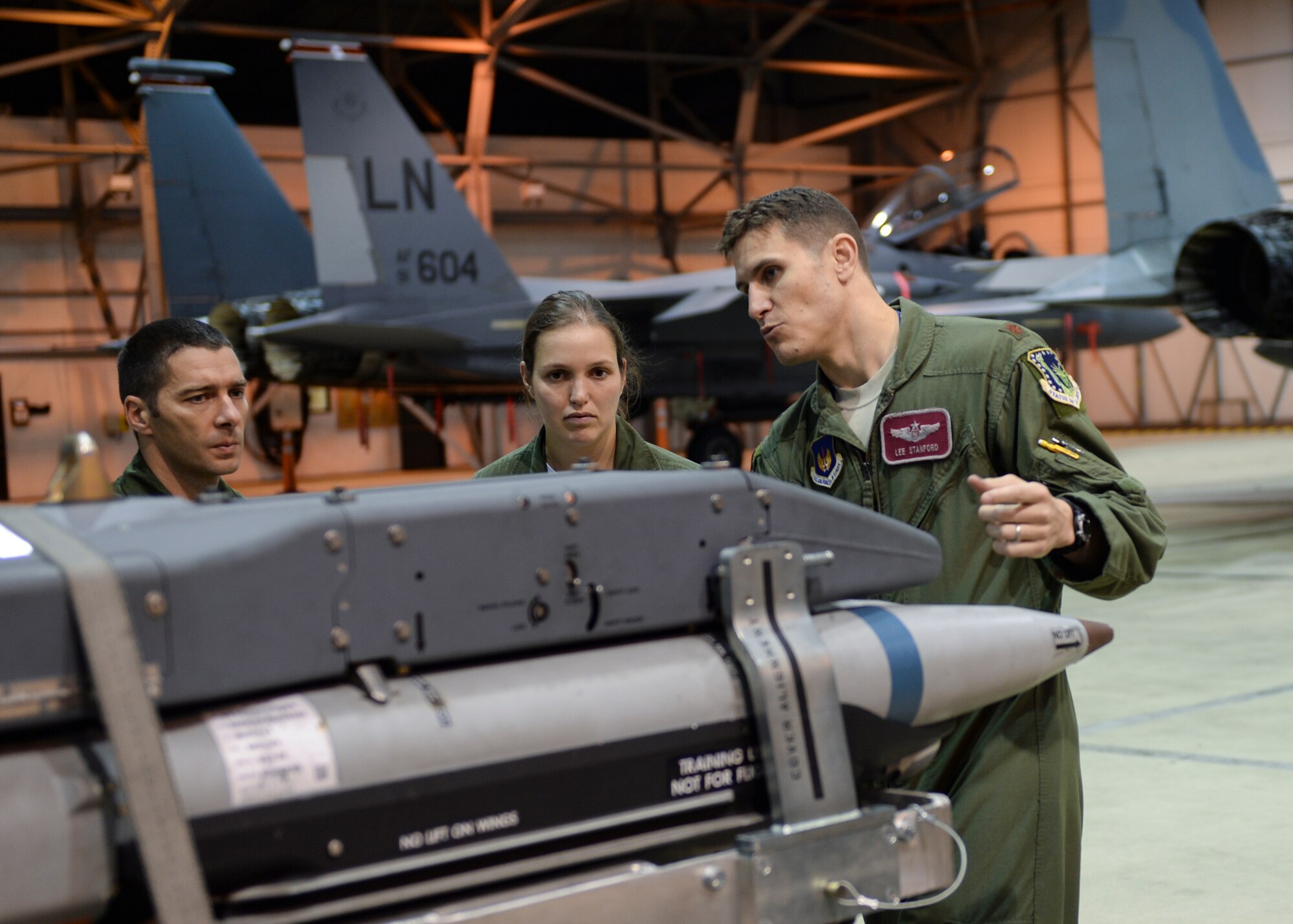 Maj. Lee Stanford, (right) 48th Operations Support Squadron wing weapons, shows French Air Force members munitions used on the F-15E Strike Eagle at Hangar 6 on RAF Lakenheath Oct. 4, 2013. The event was orchestrated to further strengthen the camaraderie between the U.S. and French forces. (U.S. Air Force photo by Airman 1st Class Nigel Sandridge/Released)