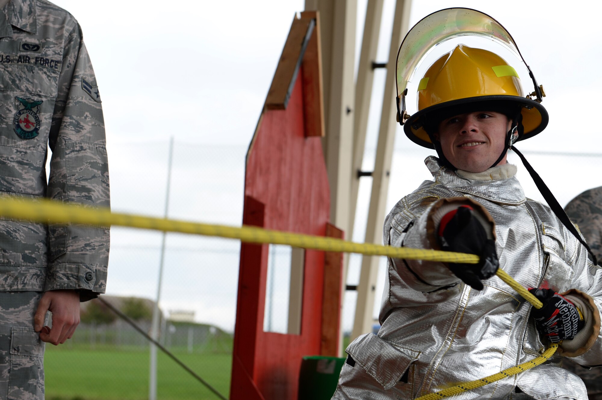 SPANGDAHLEM AIR BASE, Germany – Staff Sgt. Marshall Freitas, 52nd Equipment Maintenance Squadron crash recovery team supervisor from Virginia Beach, Va., pulls more than 150 pounds in the Spangdahlem Fire Prevention Week fire muster challenge Oct. 10, 2013. The pull was to demonstrate fire fighters’ ability to raise an extension ladder. (U.S. Air Force photo by Senior Airman Alexis Siekert/Released)