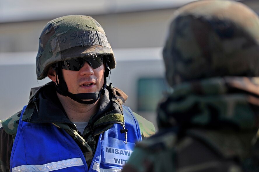 U.S. Air Force Tech. Sgt. Stephen Morin, left, 35th Maintenance Group Wing Inspection Team member, debriefs Staff Sgt. Kevin Shoultz, 35th Maintenance Squadron precision measurement equipment laboratory technician, after a post attack reconnaissance sweep at Misawa Air Base, Japan, Oct. 10, 2013. Morin has been deployed to various locations and used this experience along with prior exercise experience to better prepare Airmen for real world scenarios downrange. This was Morin’s first exercise as a WIT member. (U.S. Air Force photo by Airman 1st Class Zachary Kee)