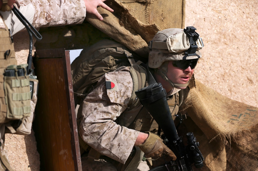 A U.S. sailor enters a compound during a patrol in Helmand province, Afghanistan, Oct. 12, 2013. The sailor is assigned to Alpha Company, 1st Battalion, 9th Marine Regiment.