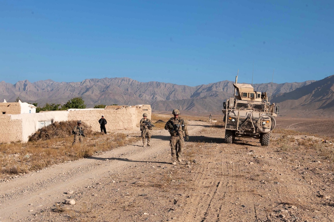 U.S. soldiers conduct a presence patrol near Forward Operating Base Shank in Afghanistan's Logar province, Oct. 8, 2013.
