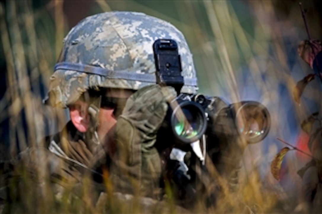 A U.S. soldier uses binoculars to scan the terrain during reconnaissance training at the 7th Army Joint Multinational Training Command's Grafenwoehr Training Area, Germany, Oct. 08, 2013, to prepare for upcoming exercise "Steadfast Jazz" in Poland. The soldier is assigned to the 1st Squadron, 91st Cavalry Regiment, 173rd Infantry Brigade Combat Team.