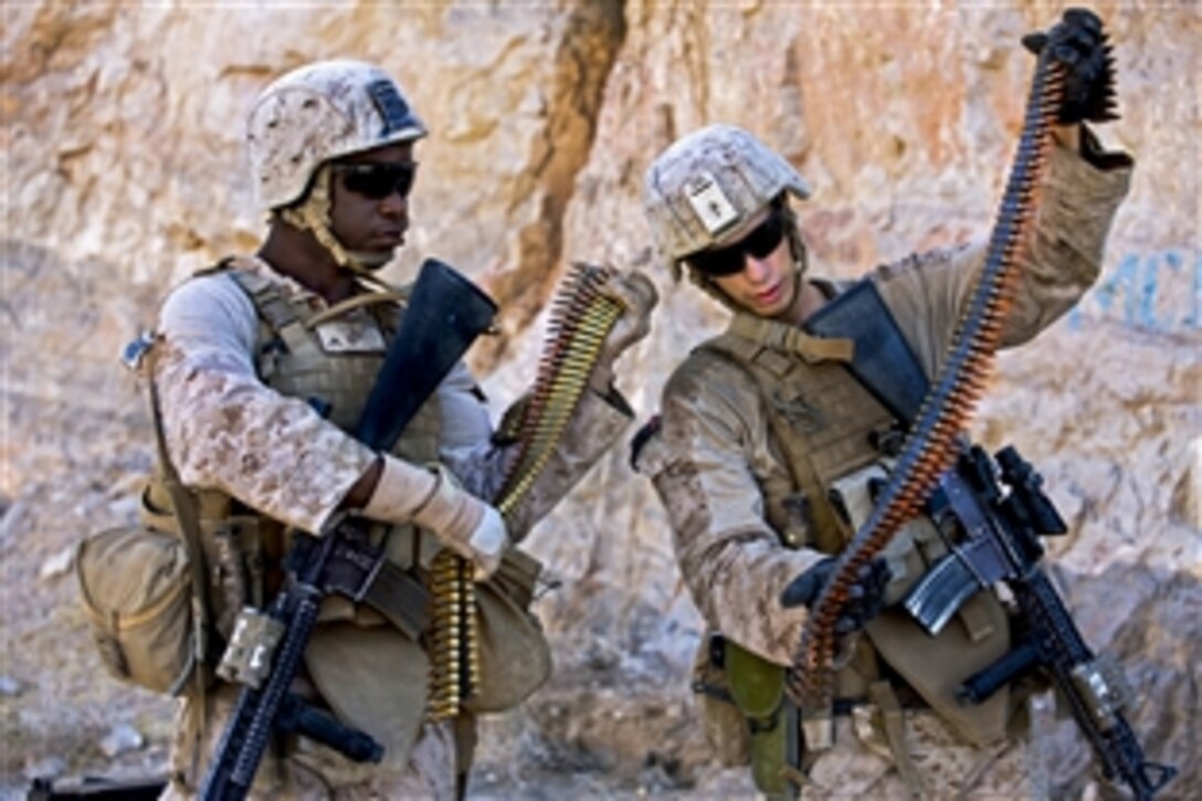 U.S. Marine Corps Lance Cpls. Roosevelt Pierre, left, and Christian Moore inspect 7.62-caliber rounds before a machine gun shoot in the Kajaki district in Afghanistan's Helmand province, Oct. 6, 2013. Pierre and Moore, machine gunners, are assigned to Lima Company, 3rd Battalion, 7th Marine Regiment. The range exercise enabled the Marines to train with the weapons. 