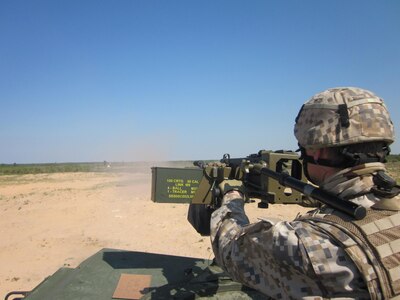 A Latvian soldier engages targets with a High Mobility Multipurpose Wheeled Vehicle mounted .50 machine gun during an exercise as part of joint U.S./Latvian training for Operation Summer Shield in Adaži, Latvia, on May 24, 2011. Latvia is paired with Michigan in the National Guard State Partnership Program.