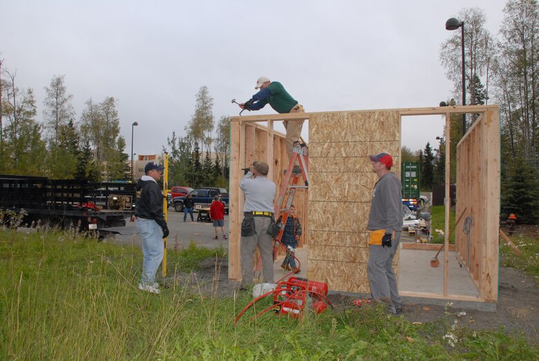 Volunteers from the U.S. Army Corps of Engineers – Alaska District; 2nd Engineer Brigade; 4th Brigade, 25th Infantry Division and the National Air Traffic Controllers Association work on framing a storage shed Sept. 21 for the Fisher House of Alaska located on Joint Base Elmendorf-Richardson.