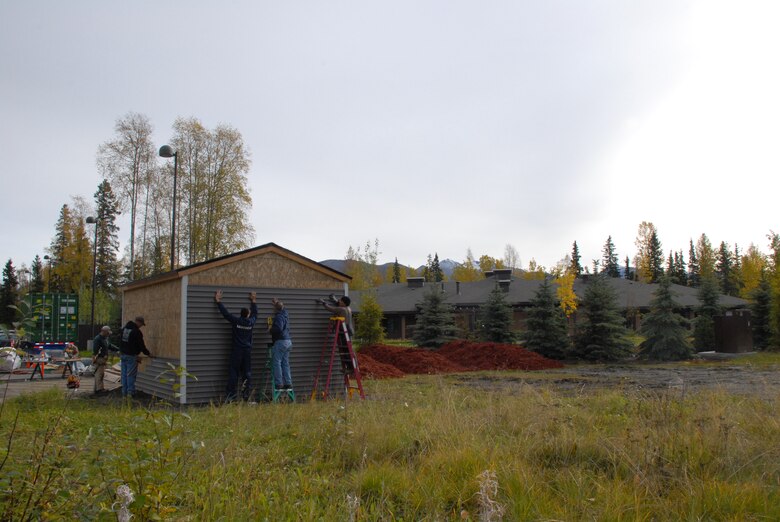 Volunteers from the U.S. Army Corps of Engineers – Alaska District; 2nd Engineer Brigade; 4th Brigade, 25th Infantry Division and the National Air Traffic Controllers Association put the finishing touches on the storage shed Sept. 28 for the Fisher House of Alaska located on Joint Base Elmendorf-Richardson. 