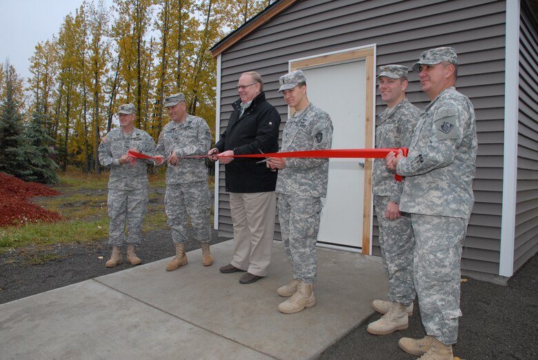 Col. Christopher Lestochi (second from left), district commander of the Alaska District, Terry Parks (middle), president of the Fisher House of Alaska board of directors, and 1st Lt. Dan Frederick (third from right), engineer with the 2nd Engineer Brigade, cut the ribbon Oct. 2 to a new storage shed at the Alaska Fisher House located on Joint Base Elmendorf-Richardson during a dedication ceremony.