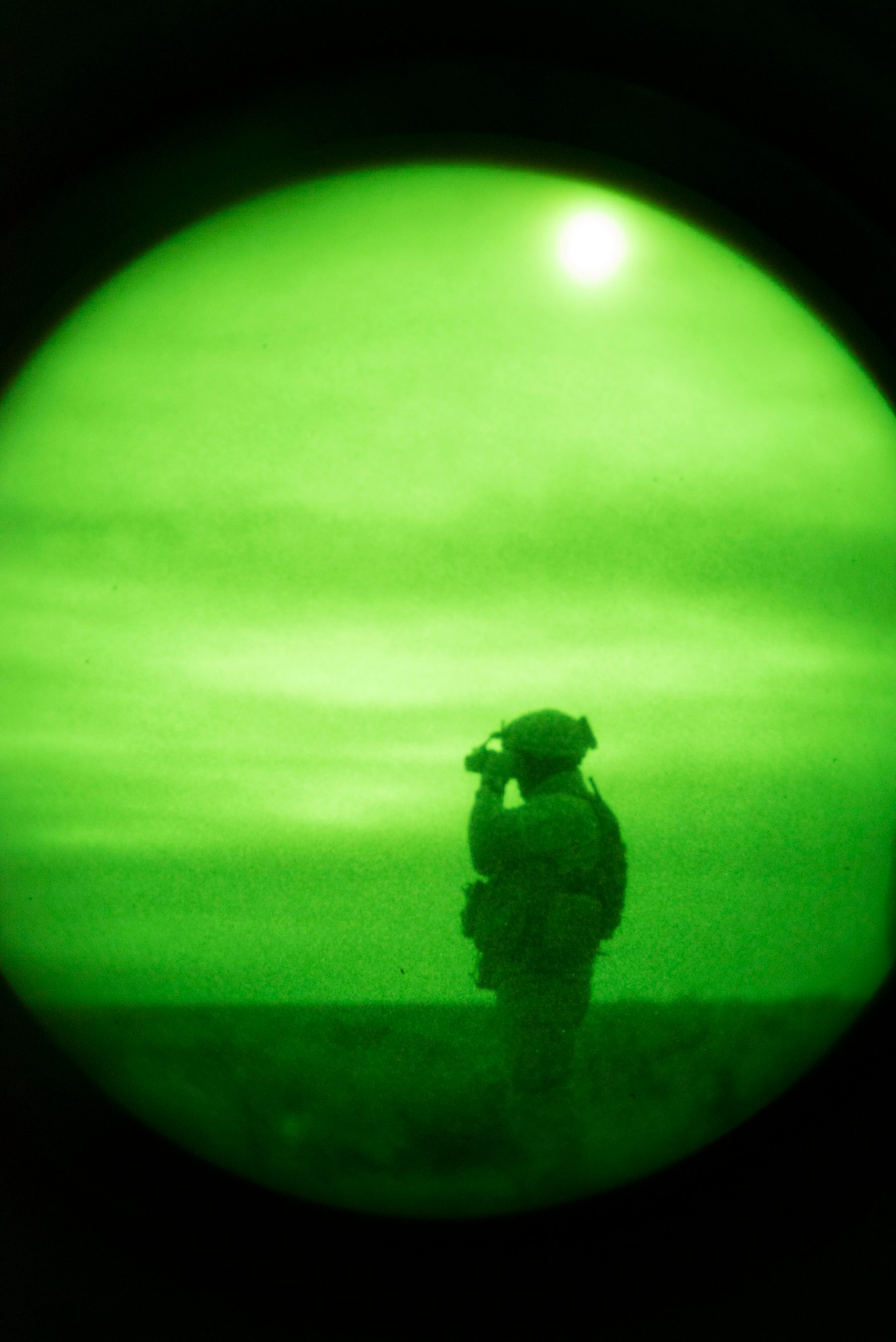 U.S. Marine Cpl. Daniel Soto, 1st Air Naval Gunfire Liaison Company Supporting Arms Liaison Team Delta forward air controller, scans the desert for targets during a night close-air support scenario at Juniper Butte bombing range near Mountain Home Air Force Base, Idaho, Oct. 8, 2013. Many U.S. Air National Guard and Air Force participants could not participate in Mountain Roundup, which kicked-off Sept. 30 and ends Oct. 16, because of the government shutdown. Air support in the exercise came from 391st Fighter Squadron F-15E Strike Eagles, Republic of Singapore Air Force F-15SG Strike Eagles, U.S. Navy AV-8B Harriers and German Air Force AG-51 Tornados. (U.S. Air Force photo by Master Sgt. Kevin Wallace/RELEASED)