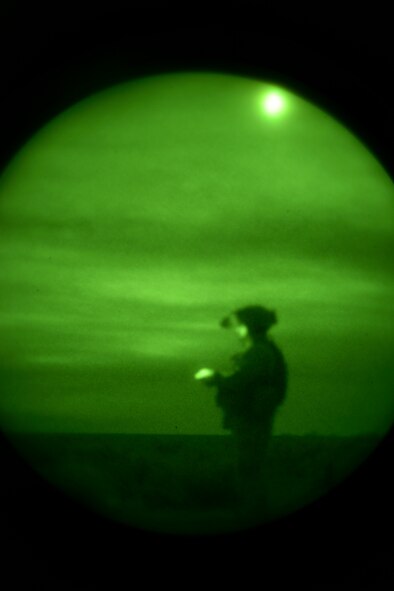 U.S. Marine Cpl. Daniel Soto, 1st Air Naval Gunfire Liaison Company Supporting Arms Liaison Team Delta forward air controller, scans the desert for targets during a night close-air support scenario at Juniper Butte bombing range near Mountain Home Air Force Base, Idaho, Oct. 8, 2013. Air support in the exercise came from 391st Fighter Squadron F-15E Strike Eagles, Republic of Singapore Air Force F-15SG Strike Eagles, U.S. Navy AV-8B Harriers and German Air Force AG-51 Tornados. (U.S. Air Force photo by Master Sgt. Kevin Wallace/RELEASED)