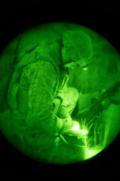 U.S. Marine Capt. Chris Walker, 1st Air Naval Gunfire Liaison Company Supporting Arms Liaison Team Delta joint terminal attack controller, annotates coordinates during a night close-air support scenario at Juniper Butte bombing range near Mountain Home Air Force Base, Idaho, Oct. 8, 2013. Air support in the exercise came from 391st Fighter Squadron F-15E Strike Eagles, Republic of Singapore Air Force F-15SG Strike Eagles, U.S. Navy AV-8B Harriers and German Air Force AG-51 Tornados. (U.S. Air Force photo by Master Sgt. Kevin Wallace/RELEASED)