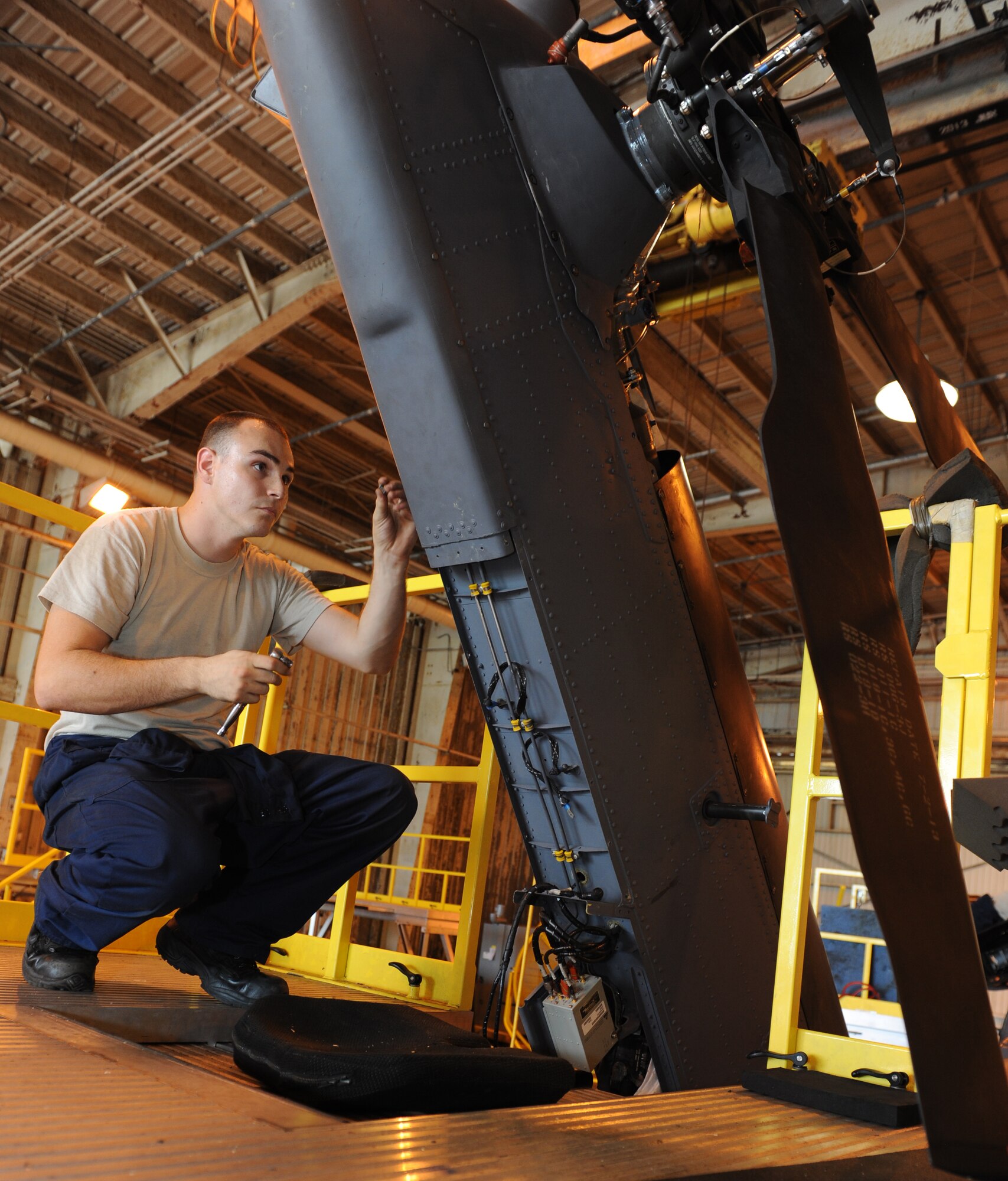U.S. Air Force Staff Sgt. Dustin Unger, 33rd Helicopter Maintenance Unit HH-60G Pave Hawk crew chief, dry fits for sheet metal repair on a Pave Hawk on Kadena Air Base, Japan, Oct. 15, 2013. The unit is responsible for the maintenance and overall repair of the unit's aircraft, ensuring that they are mission capable and ready to provide support for search and rescue efforts throughout the Pacific theater. (U.S. Air Force photo by Airman 1st Class Keith A. James)