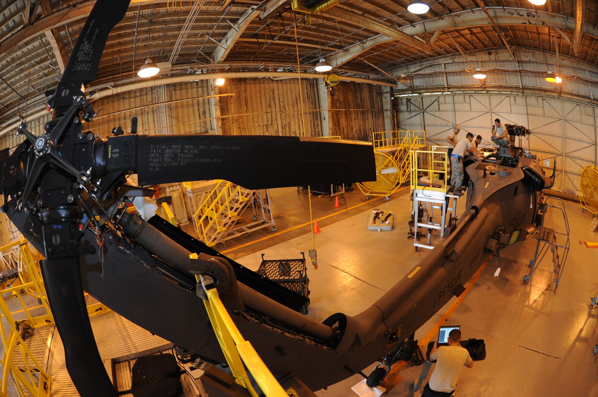 Members of the 33rd Helicopter Maintenance Unit work on a HH-60G Pave Hawk helicopter on Kadena Air Base, Japan, Oct. 15, 2013. The unit is responsible for the maintenance and overall repair of the unit's aircraft, ensuring that they are mission capable and ready to provide for support search and rescue efforts throughout the Pacific theater. (U.S. Air Force photo by Airman 1st Class Keith A. James)