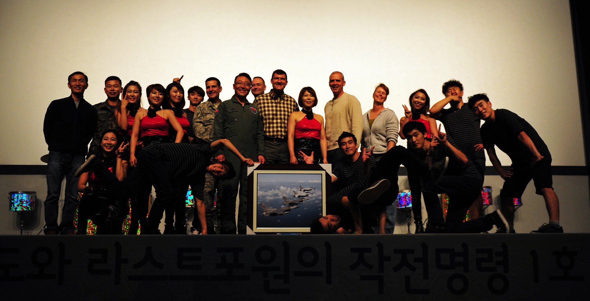 Kunsan leadership poses with member DoDo and Last for One after their live performance at Kunsan Air Base, Republic of Korea, Oct. 15, 2013. The Republic of Korea air force hosted the percussion group DoDo and break dancing crew Last for One for a concert here. The performers merged traditional Korean style drumming with western hip-hop style dancing. (U.S. Air Force photo by Senior Airman Armando A. Schwier-Morales/Released)