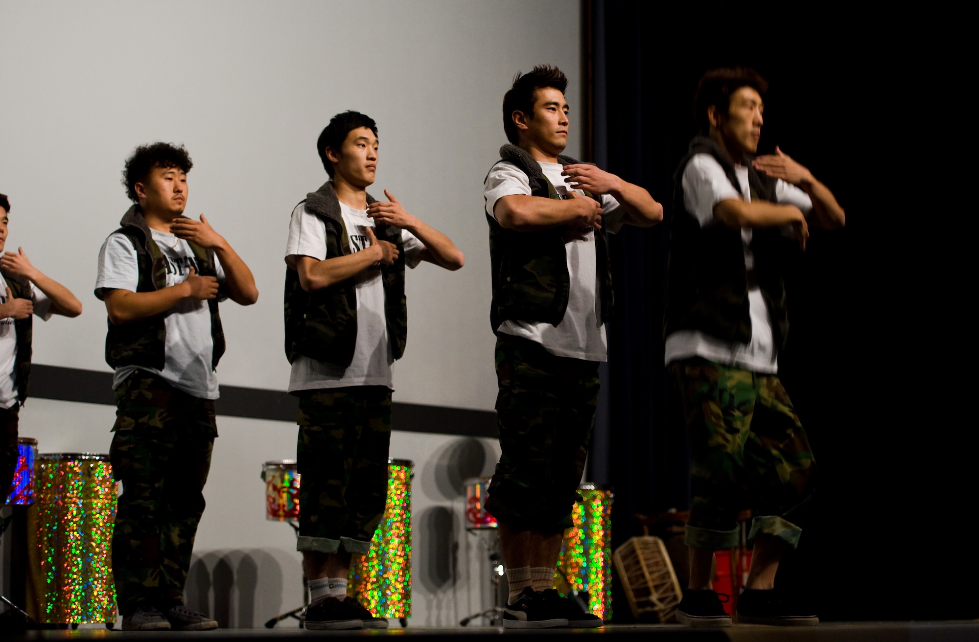 Dancers form the break dancing crew, Last for One, perform their opening dance dedicated to the Airmen at Kunsan Air Base, Republic of Korea, Oct. 15, 2013.  The Republic of Korea air force hosted the percussion group DoDo and break dancing crew Last for One for a concert here. The performers merged traditional Korean style drumming with western hip-hop style dancing. (U.S. Air Force photo by Senior Airman Armando A. Schwier-Morales/Released)