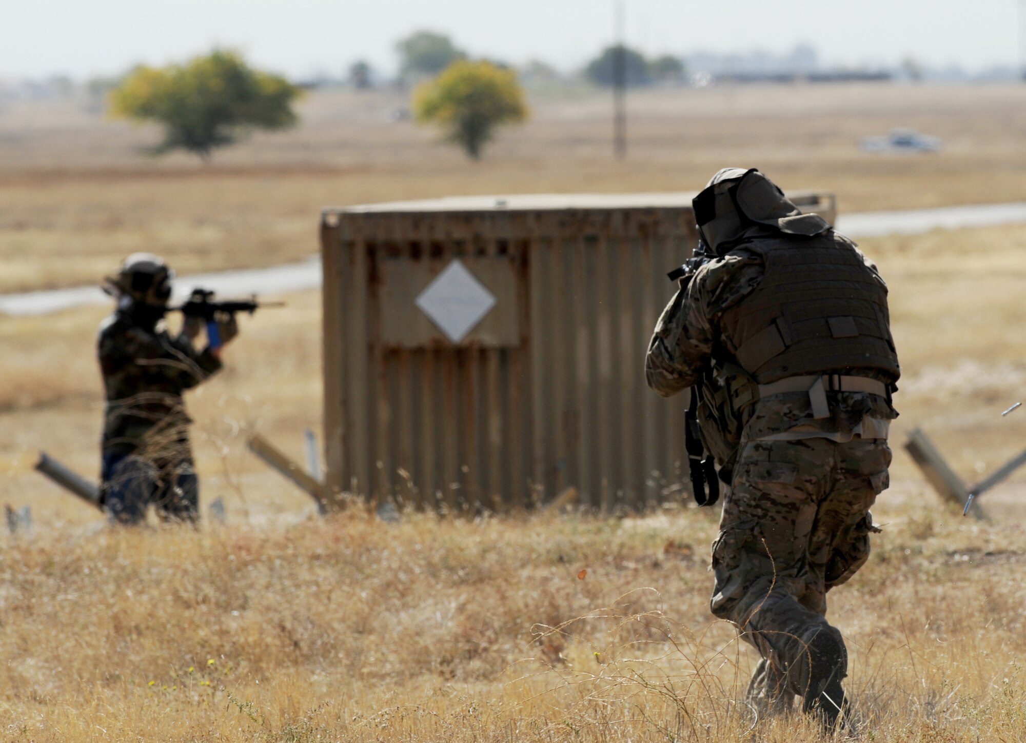 An Air Force contractor engages opposition forces with simulated rounds during a pilot-rescue exercise at Beale Air Force Base, Calif., Oct. 9, 2013. Allied forces utilized Beale's MC-12W Liberty to provide tactical intelligence, surveillance and reconnaissance. (U.S. Air Force photo by Staff Sgt. Robert M. Trujillo/Released)   