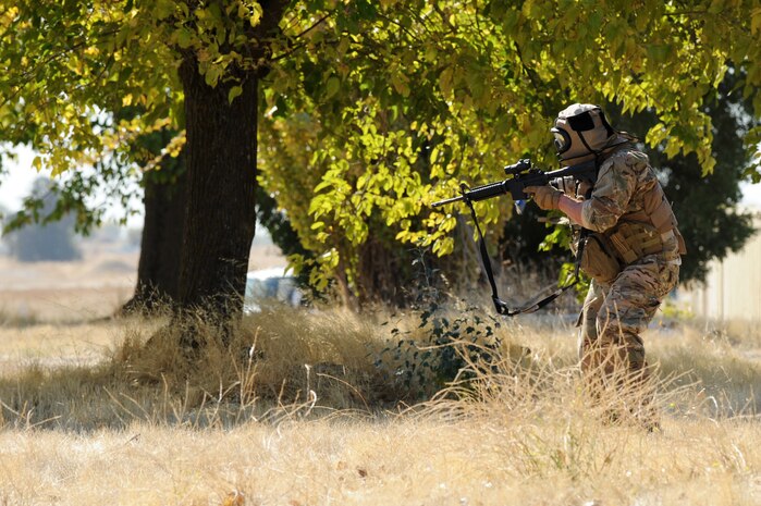 An Air Force contractor reloads an M-4 assault rifle during a pilot-rescue exercise at Beale Air Force Base, Calif., Oct. 9, 2013. Contractors partnered with members of the 9th Security Forces Squadron to rescue two simulated downed pilots. (U.S. Air Force photo by Staff Sgt. Robert M. Trujillo/Released)   