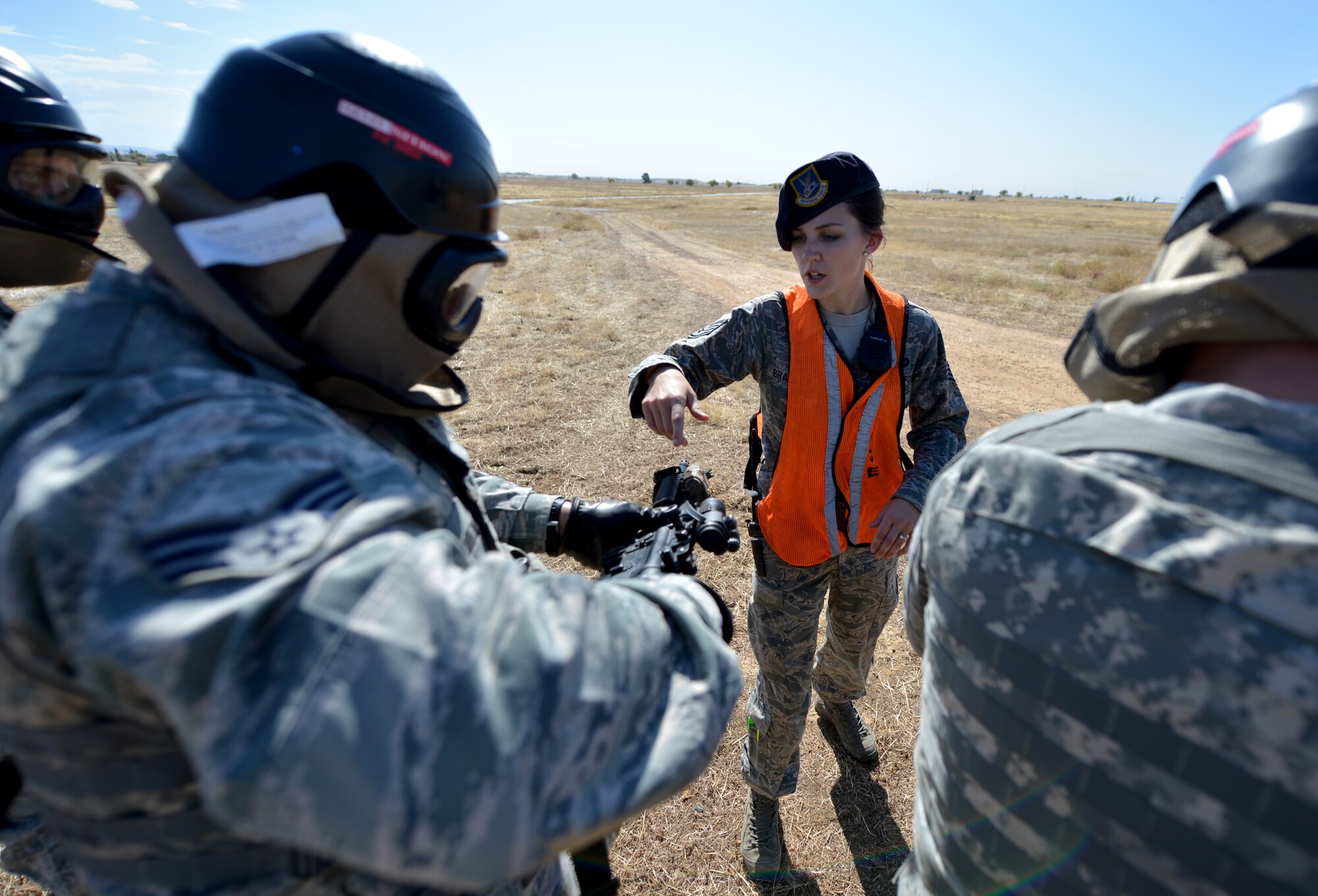 Staff Sgt. Kirsten Bradley, 9th Security Forces Squadron training instructor, inspects weapons during a pilot-rescue exercise at Beale Air Force Base, Calif., Oct. 9, 2013. The 9th SFS worked closely with Air Force contractors who provided first-hand knowledge of enemy tactics. (U.S. Air Force photo by Senior Airman Drew Buchanan/Released)