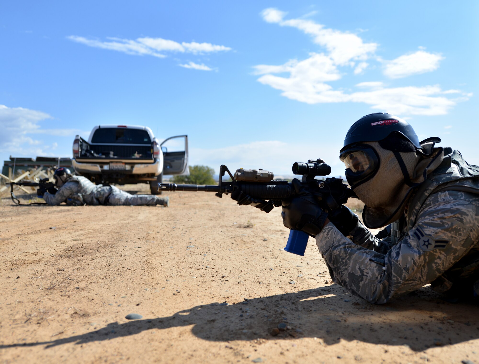 Airmen from the 9th Security Forces Squadron provide cover during a pilot-rescue exercise at Beale Air Force Base, Calif., Oct. 9, 2013. The 9th SFS used simulation and blank rounds during the scenario to provide a greater sense of realism. (U.S. Air Force photo by Senior Airman Drew Buchanan/Released)