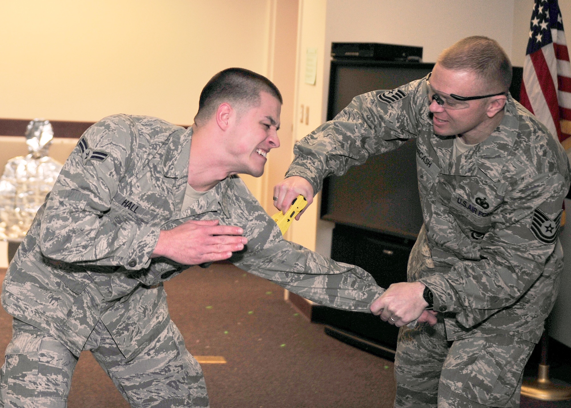 Tech. Sgt. Ryan Overcash, 354th Security Forces Squadron trainer, stuns Airman 1st Class Blair Hall, 354th SFS alarm monitor, during a Taser demonstration Oct. 15, 2013, Eielson Air Force Base, Alaska. Icemen defenders learned to use a Taser as a last resort when a subject struggles, resists, fights or flees. (U.S. Air Force photo by Senior Airman Ashley Nicole Taylor/Released)
