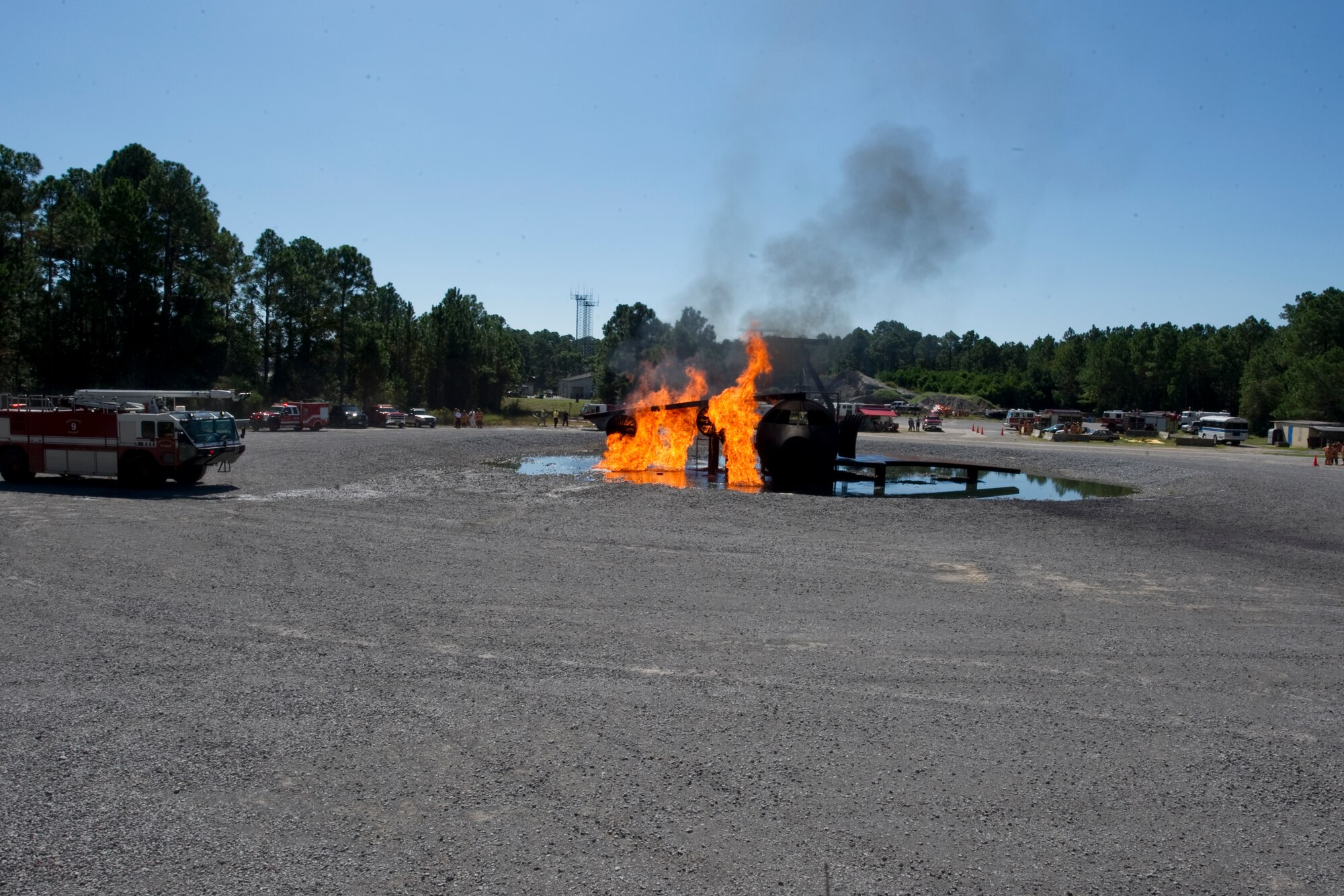 A simulated aircraft burns while the 1st Special Operations Civil Engineer Squadron fire protection flight prepares to demonstrate how to properly put out a fire at Hurlburt Field, Fla., Oct. 10, 2013. The demo served as an opportunity for Service members to experience a "day in the life" of a Hurlburt Field firefighter during Fire Prevention Week. (U.S Air Force photo/ Senior Airman Naomi Griego)