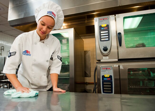 Airman 1st Class Kimberly Kimble, 99th Force Support Squadron services journeyman, cleans a table in the kitchen of the Crosswinds Dining Facility Oct. 16, 2013, at Nellis Air Force Base, Nev. The Crosswinds Dining Facility is one of two dining halls located on Nellis AFB. (U.S. Air Force photo by Airman 1st Class Thomas Spangler)