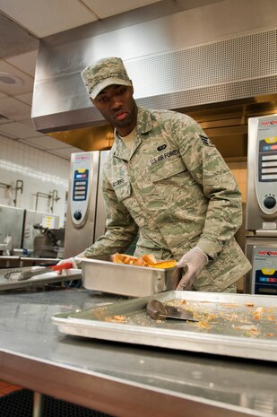 Senior Airman Gregory Rogers, 99th Force Support Squadron food services chef, prepares garlic bread at the Crosswinds Dining Facility Oct. 16, 2013, at Nellis Air Force Base, Nev. The dining facility prepares four meals every day including breakfast, lunch, dinner, and midnight snack. (U.S. Air Force photo by Airman 1st Class Thomas Spangler) 