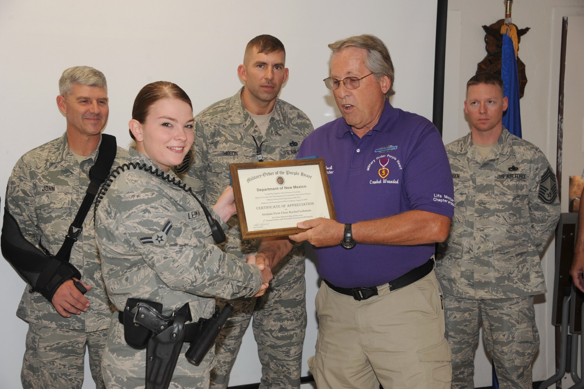 Airman 1st Class Rachel Lehman, 377th Security Forces Squadron, is presented a certificate of appreciation for her sponsorship of 2013 Fallen and Wounded Warriors golf charity. Lehman was selected by the Kirtland Chiefs Group as the September Sharp Troop Award recipient. (Photo by Dennis Carlson)