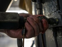 Senior Airman Robert Haberman, 437th Maintenance Squadron crew chief, hooks a hydraulic line to a jack to before using the jacks to raise the C-17 Globemaster III off the ground for a tire change Oct. 7, 2013, at Joint Base Charleston, S.C. To raise a C-17 off the ground eight jacks and six crew chiefs are required. (U.S. Air Force photo/Senior Airman Dennis Sloan) 

