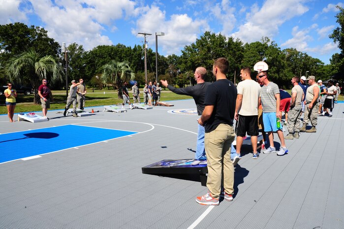 Airmen play a game of cornhole during the  2013 Oktoberfest Oct. 11, 2013, at Joint Base Charleston - Air Base, S.C. Oktoberfest is an annual event put together by the Top 3 for ranks E-1 through E-6 to show appreciation for their day-to-day hard work. The event included free food and drinks, a disc jockey and a hot wing eating contest. Airmen also played games such as basketball and corn hole. (U.S. Air Force photo/Airman 1st Class Chacarra Neal)