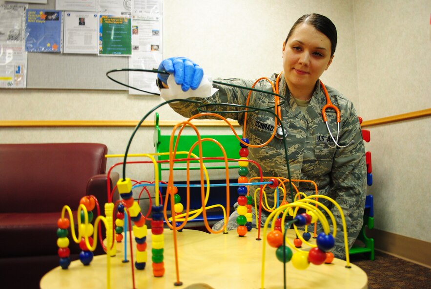 Senior Airman Samantha Conrad, 319th Medical Operations Squadron pediatric medical technician, uses disinfectant wipes to clean one of the toys used to keep children entertained at the base pediatric clinic, Oct. 15, 2013, at Grand Forks Air Force Base, N.D.   The Tacoma, Wash., native is the base’s Warrior of the Week for the second week of October 2013. (U.S. Air Force photo/Staff Sgt. Luis Loza Gutierrez) 