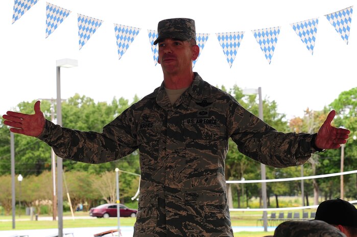 Chief Master Sgt. Shawn Hughes, 437th Airlift Wing command chief, gives opening remarks before the 2013 Oktoberfest Oct. 11, 2013, at Joint Base Charleston - Air Base, S.C. Oktoberfest is an annual event put together by the Top 3 for ranks E-1 through E-6 to show appreciation for their day-to-day hard work. The event included free food and drinks, a disc jockey and a hot wing eating contest. Airmen also played games such as basketball and cornhole. (U.S. Air Force photo/Airman 1st Class Chacarra Neal)
