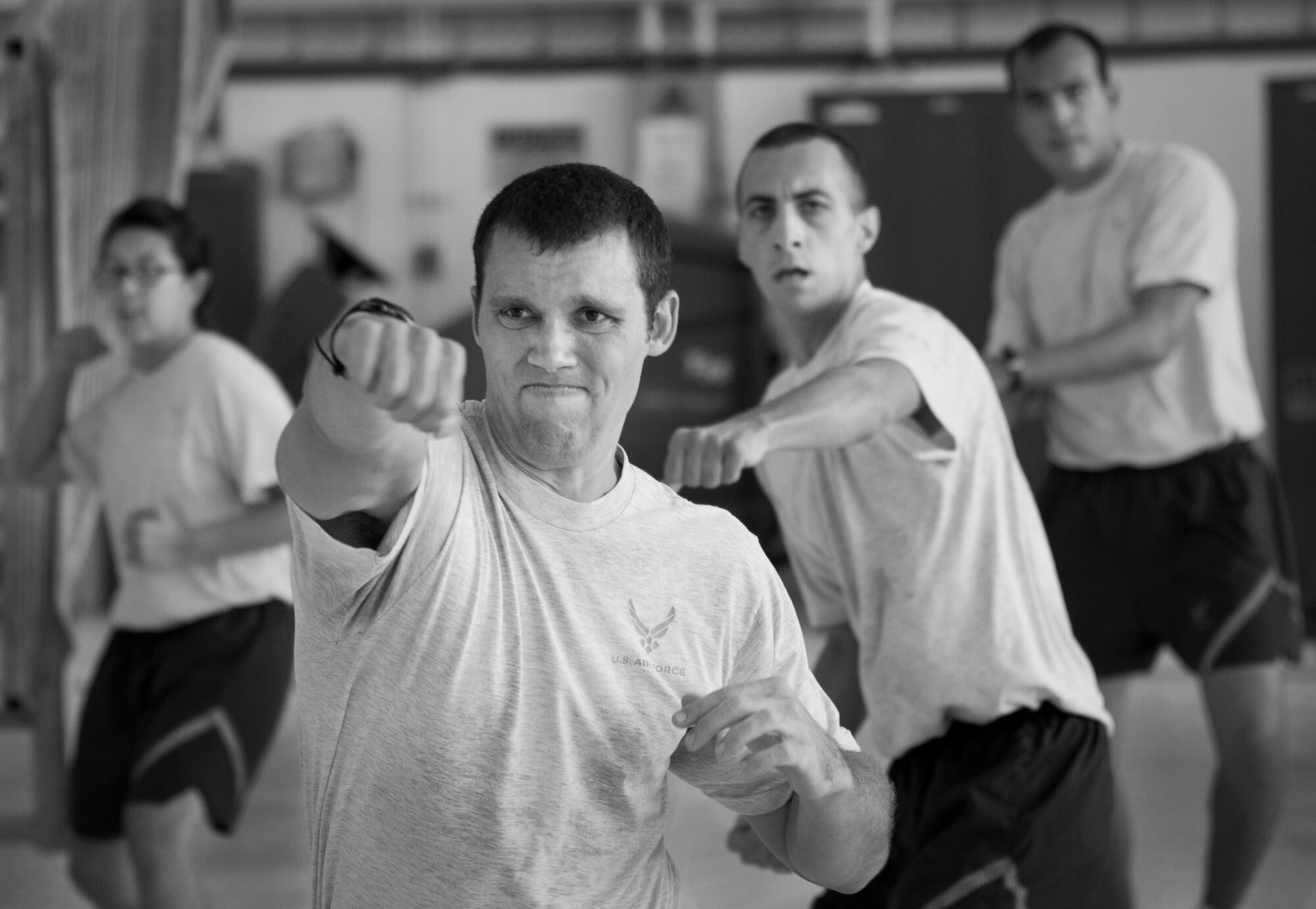 Airmen perform a punching exercise with fitness expert Tony Horton during a 90-minute workout session at Eglin Air Force Base, Fla., Oct. 16.  The workout was part of a day-long visit at Eglin.  Horton also visited Tyndall AFB and Pensacola Naval Air Station  while in the area.  (U.S. Air Force photo/Samuel King Jr.)