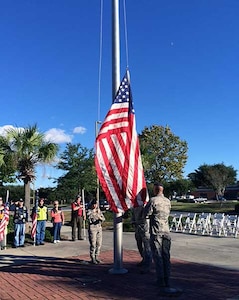 Airmen from Joint Base Charleston, S.C., lower the flag during a retreat ceremony that was held October 15, 2013, for the Vietnam Security Police Association. The Vietnam Security Police Association is a team of former active-duty Air Force Security Police members who served in Vietnam during the Vietnam War. (Courtesy photo)