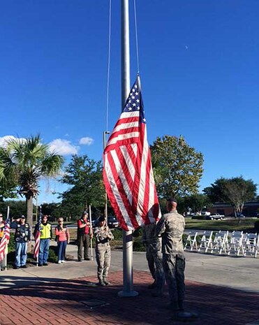 Airmen from Joint Base Charleston, S.C., lower the flag during a retreat ceremony that was held October 15, 2013, for the Vietnam Security Police Association. The Vietnam Security Police Association is a team of former active-duty Air Force Security Police members who served in Vietnam during the Vietnam War. (Courtesy photo)