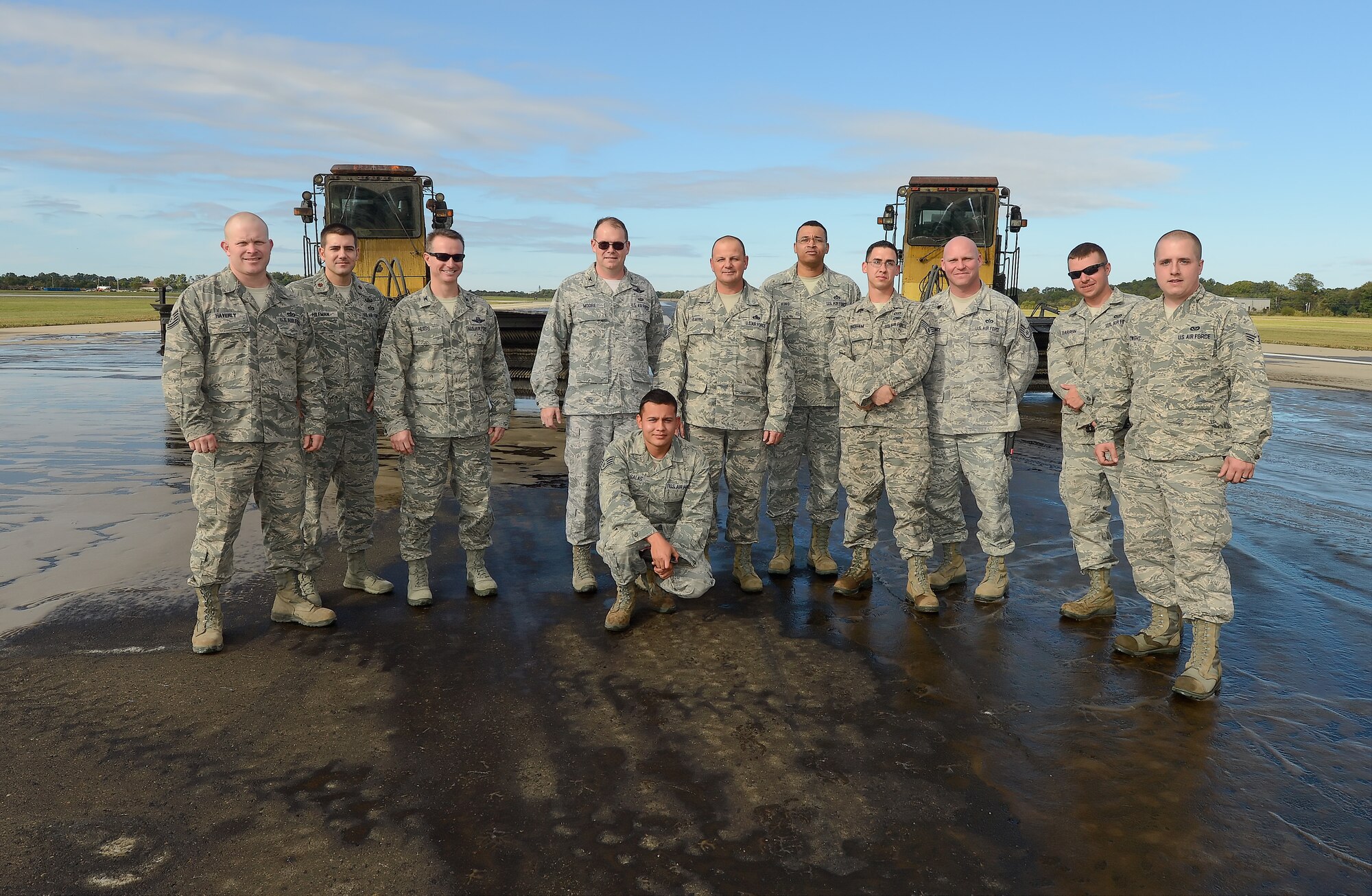 Senior leaders of the 436th Airlift Wing join with the 436th Civil Engineer Squadron pavement and heavy equipment operators section on Oct. 15, 2013, to better understand how the CE team accomplishes the task of rubber removal at Dover Air Force Base, Del. Rubber left by landing aircraft on Dover's runways is removed twice a year by the 436th CES to ensure aircraft have a clean, safe landing surface. (U.S. Air Force photo/Greg L. Davis)