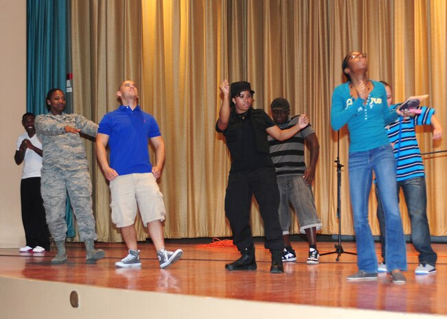 Team Beale members dance together during Air Force Sergeants Association Talent Showcase at the Beale Theater, Oct. 11, 2013. Audience voted via text message for their favorites, and the top two contestants move on to perform at Rhythm 105.9 FM’s talent showcase in Yuba City Calif., January 2014. (U.S. Air Force photo by Senior Airman Allen Pollard/Released)