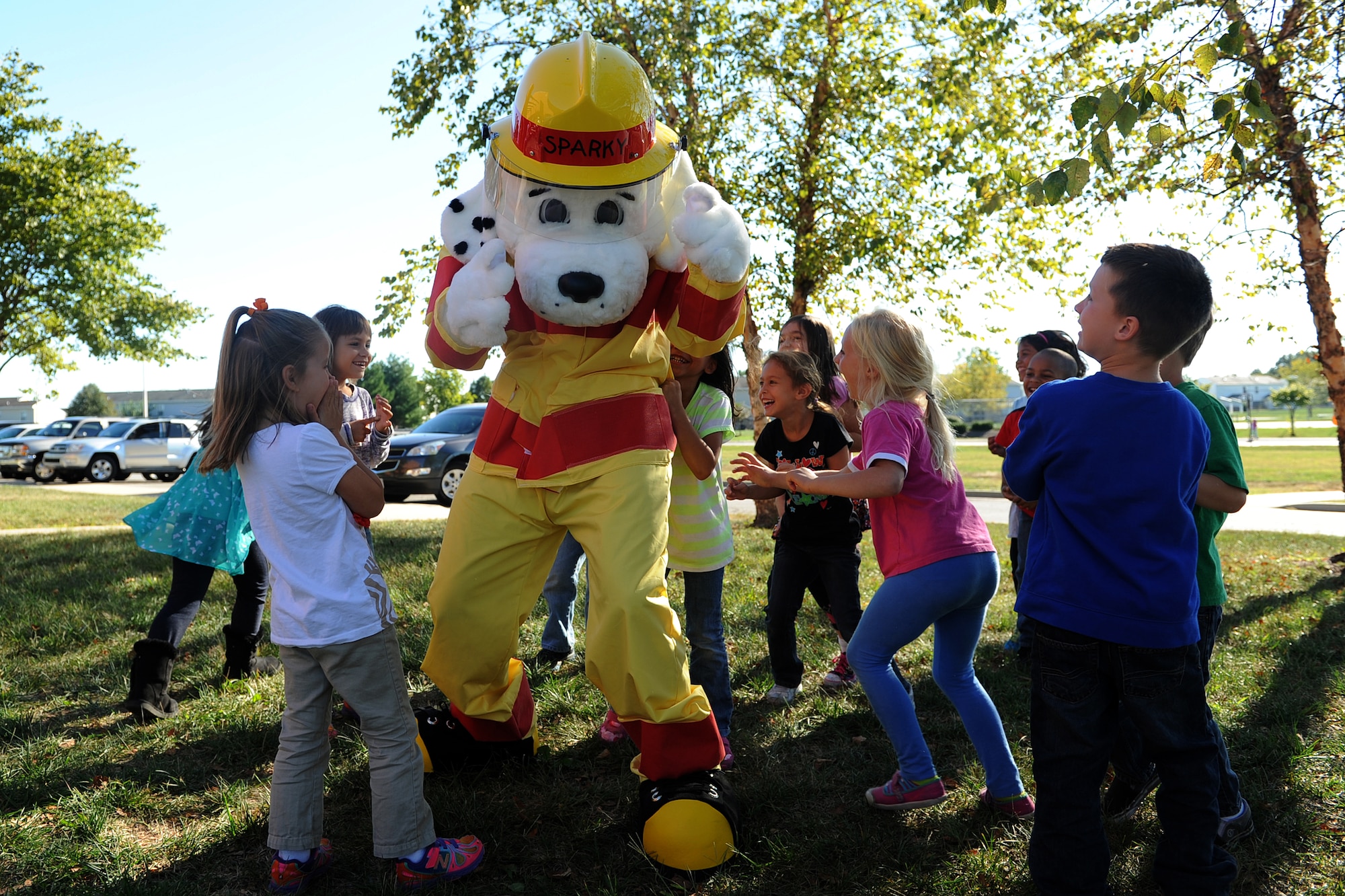 Sparky the Fire Dog plays with kids at the Youth Center during National Fire Prevention Week Oct. 8, 2013, Scott Air Force Base, Ill. This year’s theme, "Prevent Kitchen Fires," teaches kids to always have a grown-up around whenever they are cooking. (U.S. Air Force photo/Airman 1st Class Jaeda Waffer)