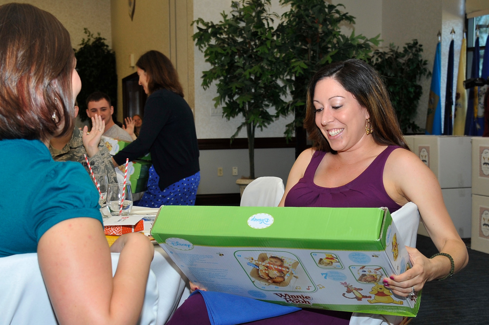 Alisha Stockman expresses joy after receiving a gift during a baby shower hosted by Operation Shower Oct. 8, 2013, Scott Air Force Base, Ill. Operation Shower, a non-profit organization, was established in 2007 and has hosted showers for more than 1,600 woman and families. (U.S. Air Force photo/Staff Sgt. Christopher Boitz)