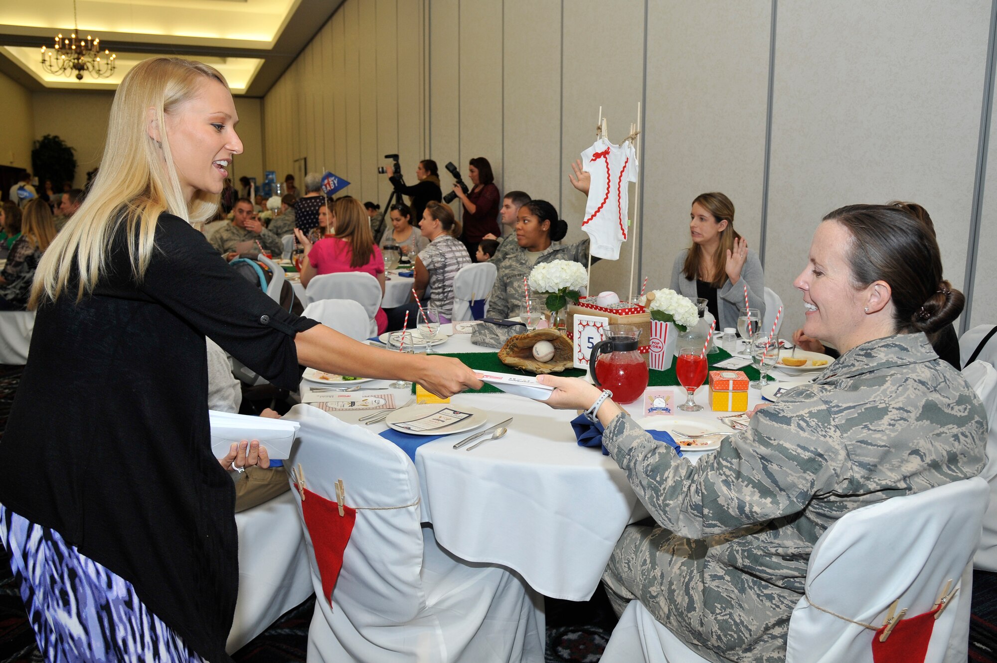 Maj. Kathryn Shaw received a note from Michelle Obama and Jill Biden thanking her and other military mothers for their continued service at the Scott Club at Scott Air Force Base, Oct. 8. Along with the notes the mothers received multiple gifts to help the ease of having a baby. (U.S. Air Force photo/Staff Sgt. Christopher Boitz)