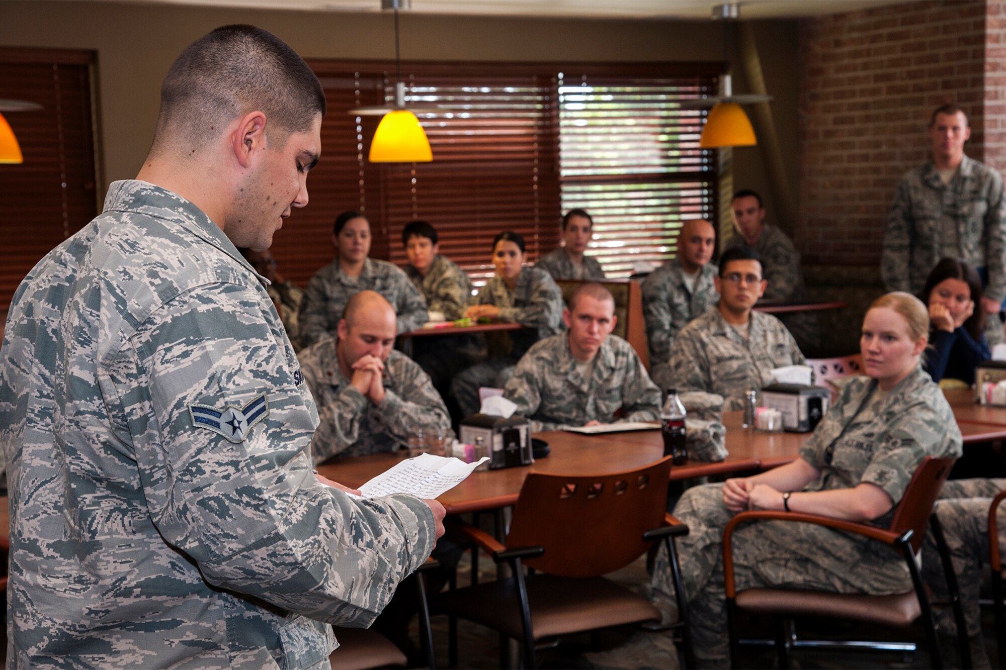 PETERSON AIR FORCE BASE, Colo. – Airman 1st Class Alexander Smalldon, 21st Security Forces Squadron, reads his speech explaining what the uniform means to him as a first term Airman during the First Term Airman Course Hand-off Luncheon Sept. 19 at the Aragon dining facility. Smalldon was one of two Airmen who volunteered to speak during the luncheon. (U.S. Air Force photo/Craig Denton)