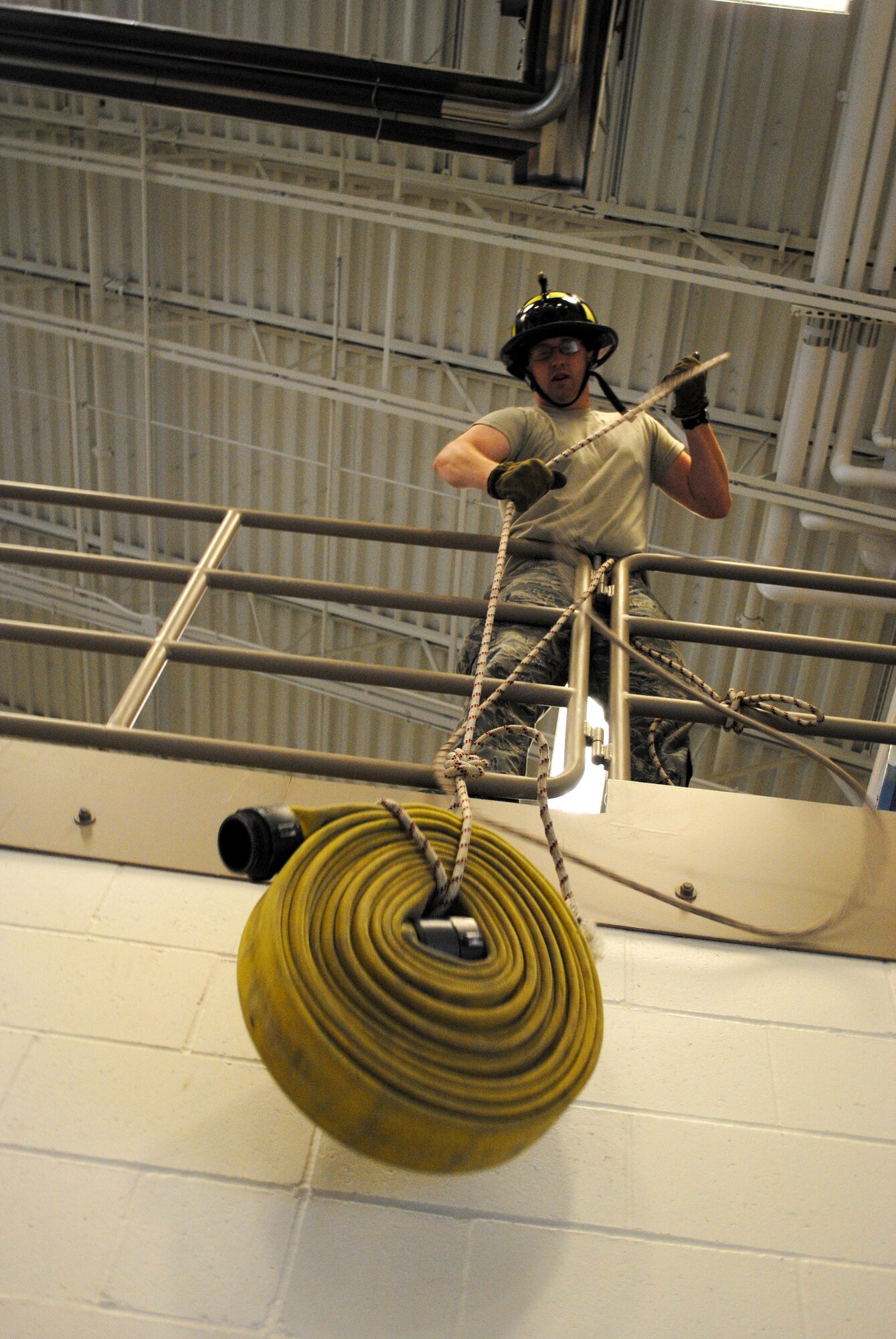 Senior Airman Benjamin Hitzelberger, Grand Forks Air Force Base fireman, performs the fire hose pull portion of the firefighter challenge obstacle course during the fire department’s open house Oct. 11, 2013. The firefighter challenge obstacle course was one of the main features of the open house, which was the final event for this year’s Fire Prevention Week events on Grand Forks AFB, N.D. (U.S. Air Force photo/Staff Sgt. Luis Loza Gutierrez
