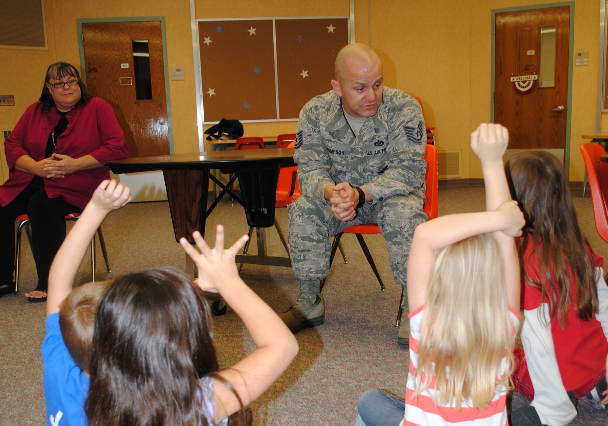 Tech. Sgt. Joshua Thompson, assistant chief of fire prevention, answers fire safety questions from first-grade students at Eielson Elementary, Oct. 8, 2013, on Grand Forks Air Force Base, N.D. The base fire department held multiple question and answer sessions at the two schools on base as part of a series of events for this year’s Fire Prevention Week. (U.S. Air Force photo/Staff Sgt. Luis Loza Gutierrez) 
