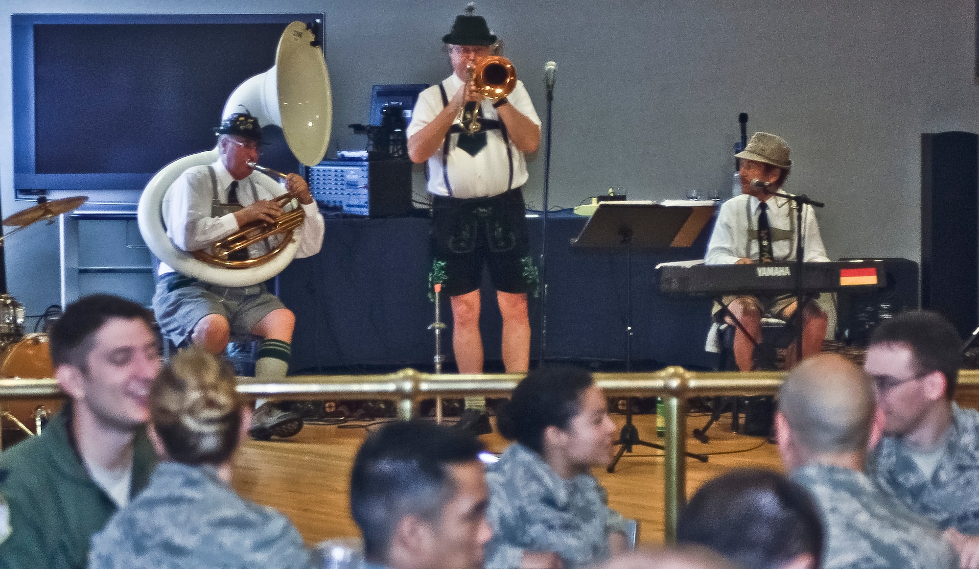 Service members listen to “The Happy Dutchmen,” a local German band, during the second annual Oktoberfest at the club on Langley Air Force Base, Va., Oct. 11, 2013. The event was designed to boost morale and camaraderie for military personnel.  (U.S. Air Force photo by Senior Airman Connor Estes/Released)