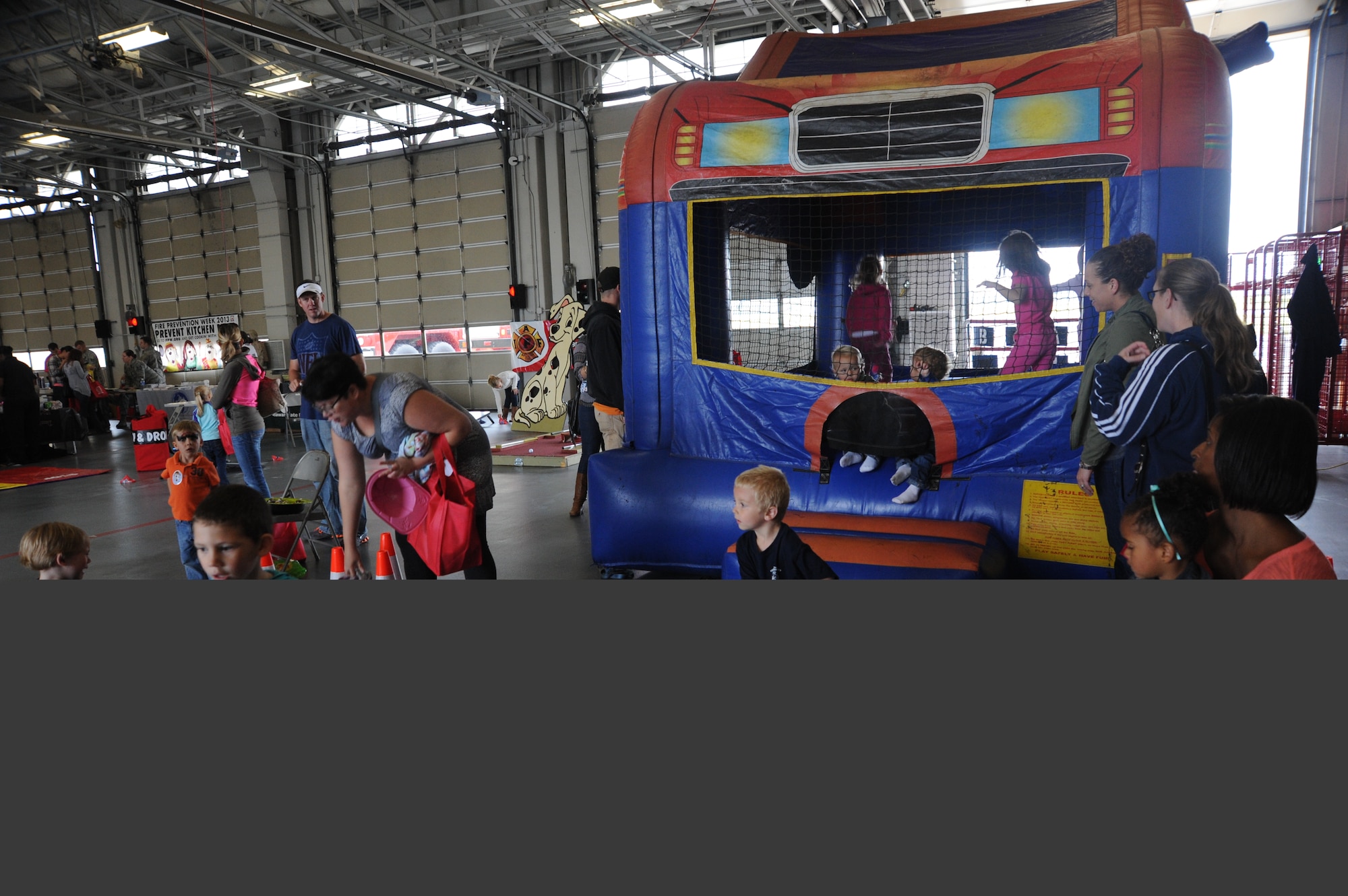 Team Dover children play in a bounce house during the Military Appreciation Picnic Oct. 12, 2013, at the fire department on Dover Air Force Base, Del. The Military Appreciation Picnic was combined with the fire prevention week open house and was hosted by the 436th Civil Engineer Squadron fire department and the Capital City Rotary Club. (U.S. Air Force photo/Staff Sgt. Elizabeth Morris)