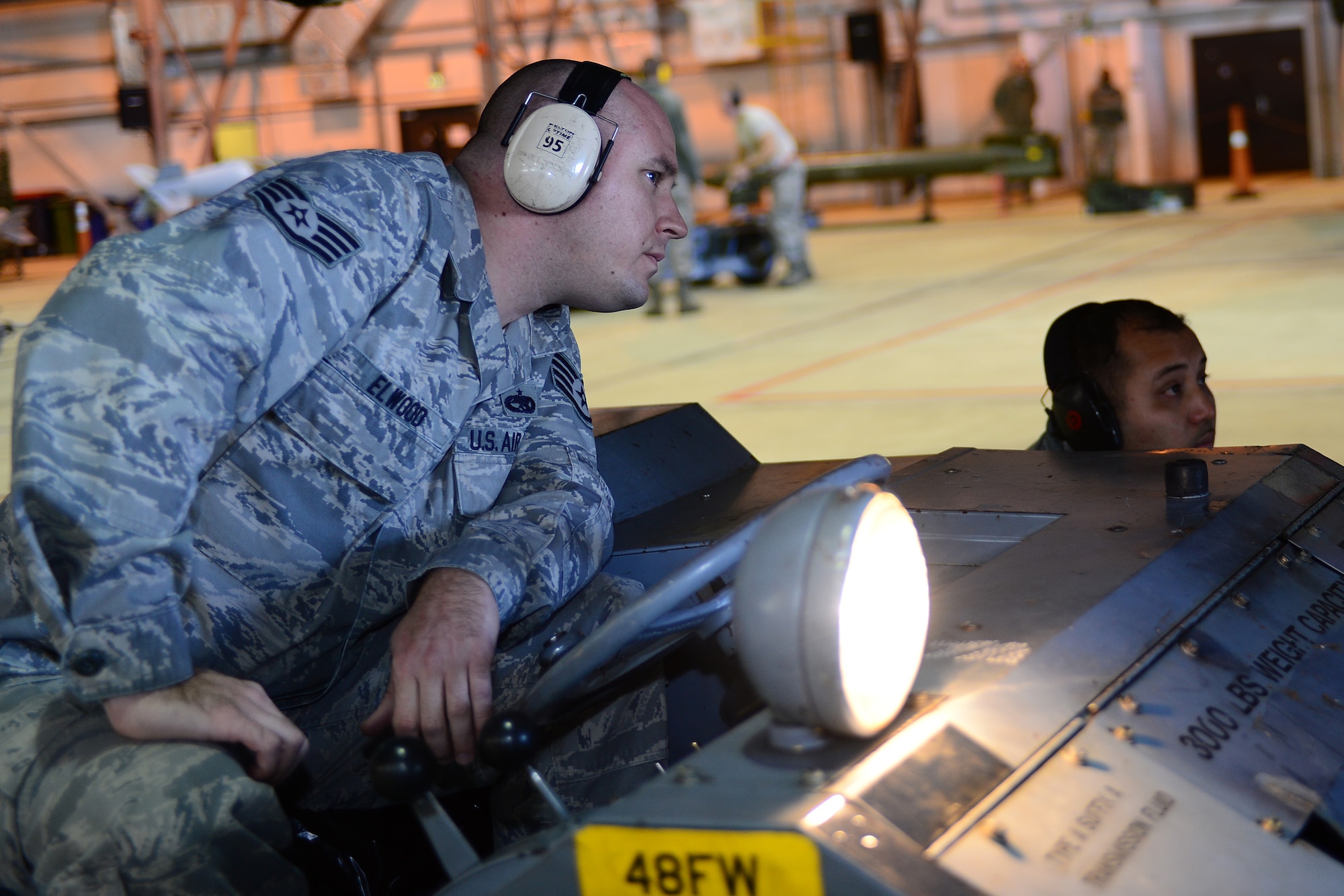 Staff Sgt. Mitchell Elwood, 493rd Aircraft Maintenance Unit weapons load crew member, transports munitions on an MJ-1 Lift Truck during the Royal Air Force Lakenheath, England, Load Crew of the Quarter competition Oct. 10, 2013. The competition featured the best load crew teams from the 492nd, 493rd, 494th AMUs and 48th Munitions Squadron. The winner was determined by the fastest time loading munitions with the least amount of errors. (U.S. Air Force photo by Airman 1st Class Dana J. Butler/Released) 