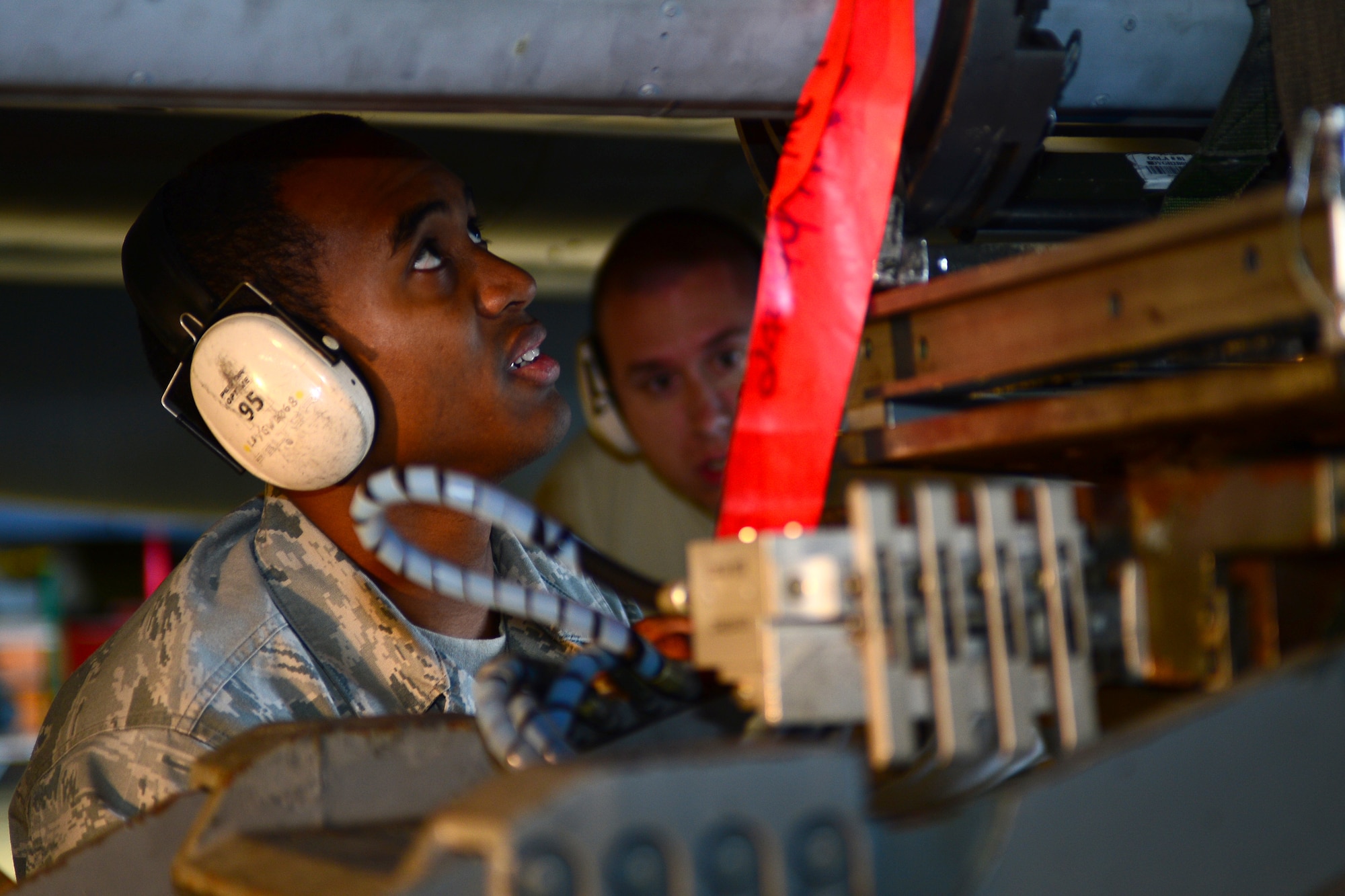 Airman 1st Class Orlando Grigley, 493rd Aircraft Maintenance Unit weapons load crew member, prepares an F-15E Strike Eagle for munitions loading during the Royal Air Force Lakenheath, England, Load Crew of the Quarter competition Oct. 10, 2013. The competition featured the best load crew teams from the 492nd, 493rd and 494th AMUs. The winner was determined by the fastest time loading munitions with the least amount of errors. (U.S. Air Force photo by Airman 1st Class Dana J. Butler/Released) 