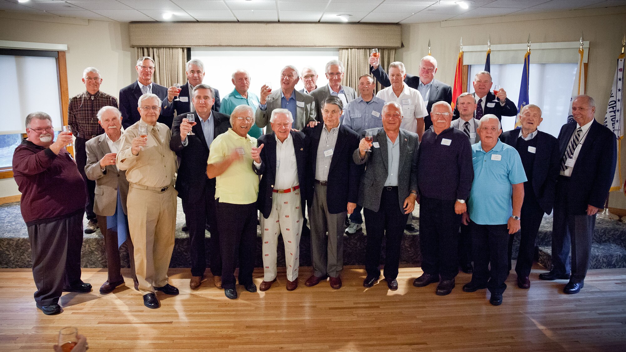 Col. Darrell Young, 934th Airlift Wing commander, raises his glass in a toast with veterans of the Vietnam, Korean, and World War II eras from the 96th Airlift Squadron Association.  The 70th anniversary of the squadron was celebrated in September with a reunion at the Officer's Club at Minneapolis-St. Paul Air Reserve Station, Minn. (U.S. Air Force photo/Shannon McKay)